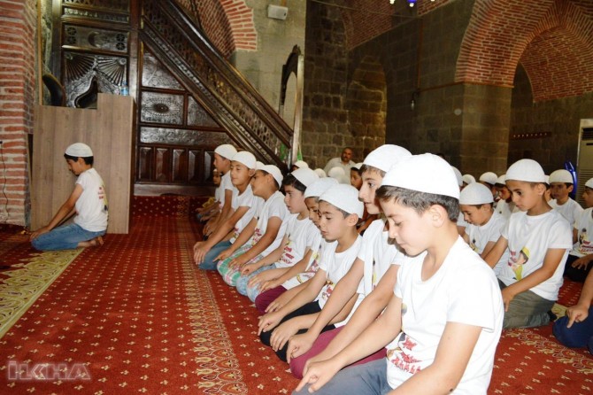 Children participating in prayer activity form colorful images