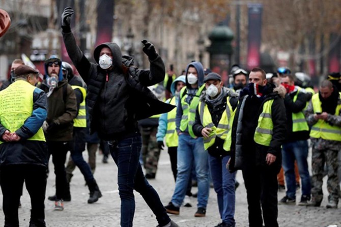 Demonstrators marching down to Champs-Elysee