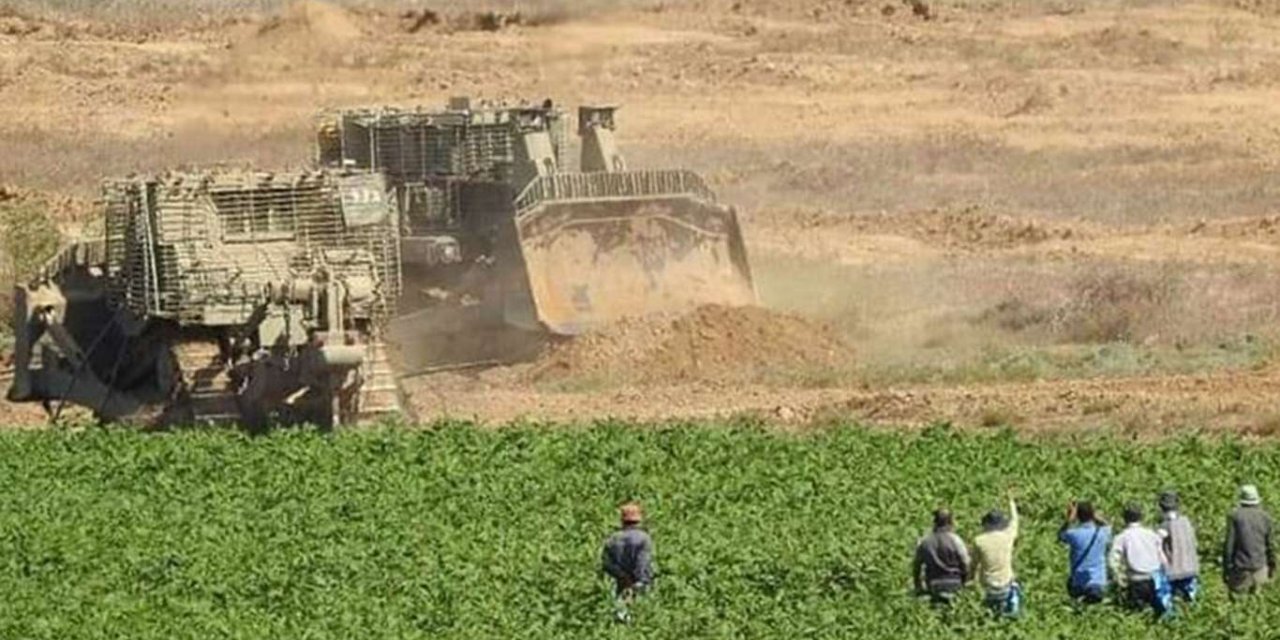 Zionist army bulldozers level land in Gaza